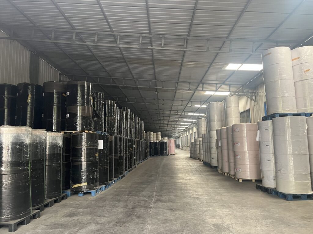 White and black wrapped jumbo rolls stacked in the warehouse