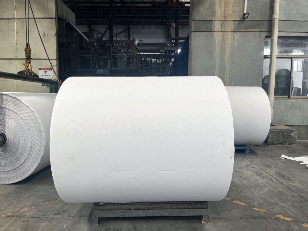 Jumbo thermal paper roll standing on a pallet